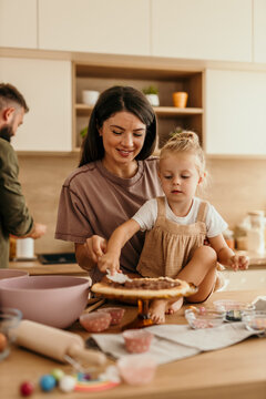 Mother and daughter baking together in kitchen