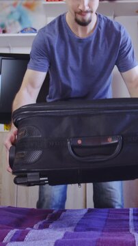 Unpacking the travel suitcase with cat hiding inside