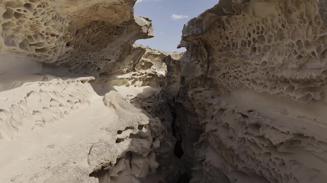 Aerial drone flying through eroded sandstone canyon formations, Mangystau, Kazakhstan