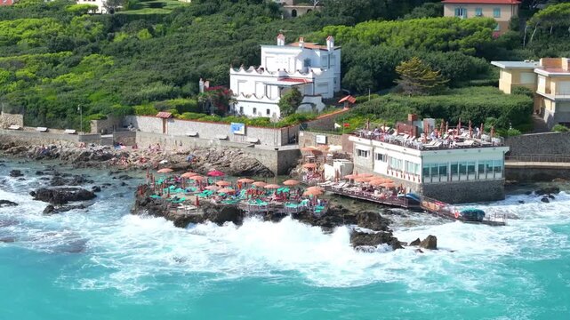 beachside lodging and waves crashing over the luxury hotel destination in Castiglioncello, Italy
