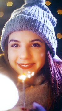 Young woman with a sparkler enjoying time for Christmas