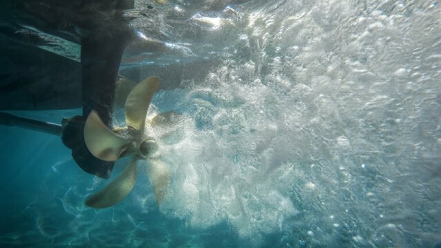 churning. A boat propeller churning water, creating a dense cloud of white bubbles and froth. mobility guides, transit brochures, designed for transport & logistics marketing.