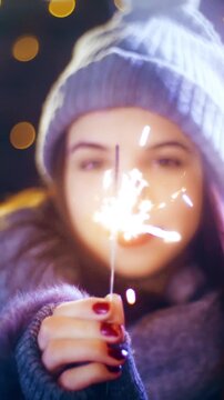 Young woman with a sparkler enjoying time for Christmas