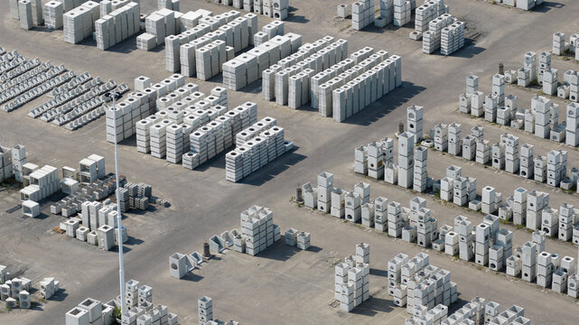 Aerial view of stacks of precast concrete blocks and industrial components organized in an outdoor storage yard in Oosterhout, North Brabant, Netherlands.