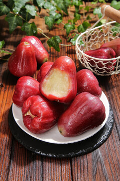 Fresh Red Wax Apples Rose Apples Hainan Tropical Fruit Diamond Lotus Variety on Wooden Table with Basket