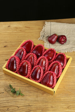 Fresh Red Wax Apples in Gift Box - Hainan Tropical Fruit Display on Wooden Background