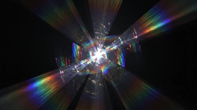 Rainbow light prism diffraction effect on black background.