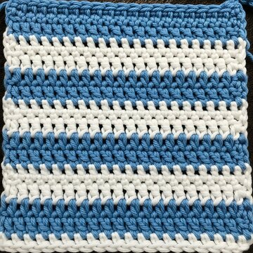 Blue and White Crocheted Fabric Square with Striped Texture in Close Up View