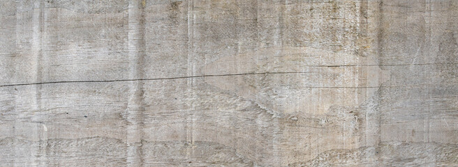 Fototapeta premium Weathered grey wooden board texture with natural grain and cracks as panoramic background