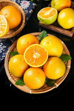 Fresh Organic Oranges Cut Pieces in Wicker Baskets with Mint Leaves Summer Citrus Fruit Display
