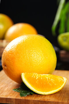 Fresh Orange Fruit Cut Wedge with Juicy Flesh on Wooden Board - Hubei Zigui Citrus Rich in Vitamins