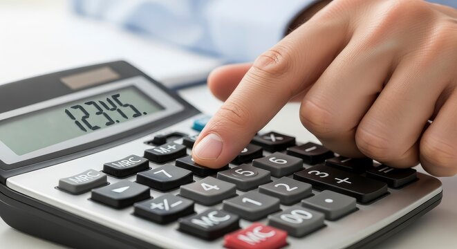 Close-up of a businessman's hand using a digital calculator for financial planning and accounting analysis