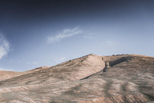 Rocky mountain slopes in the Pamir Mountains in Tajikistan, a minimalist landscape and rocky hills in sunny weather