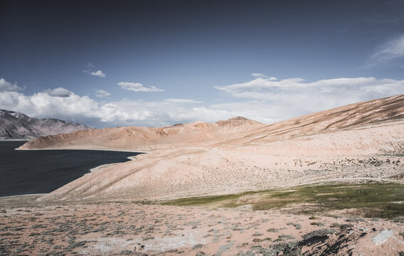 Rocky mountain slopes in the Pamir Mountains in Tajikistan, a minimalist landscape and rocky hills in sunny weather
