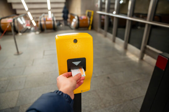 Passenger validating public transport ticket in Prague metro station. Urban transportation system and daily commuting in Czech Republic.