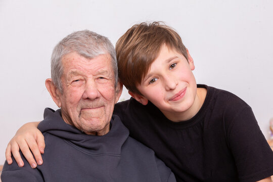 Grandfather and grandson share a joyful moment together in a warm embrace at home