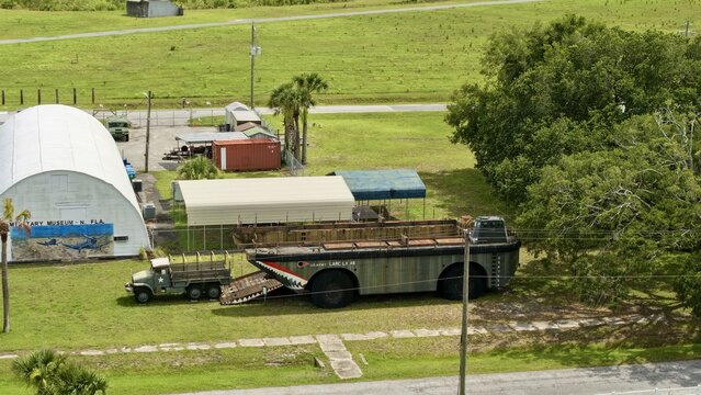 Aerial view of the Military Museum of North Florida with a LARC-LX amphibious vehicle and military truck on green grass in Green Cove Springs, Florida, United States.