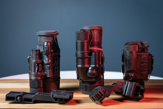 TALLINN, ESTONIA - JUNE 1, 2026: Tactical optics collection featuring MUM-14 and GT-14 night vision devices, FLIR Breach PTQ136 thermal monocular, and mounting adapters