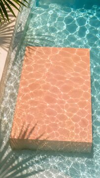 Minimalist Summer Sale Background with Turquoise Swimming Pool Water Ripples and Terracotta Block with Copy Space