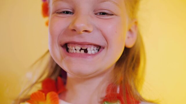 Ultra Close-Up Happy Little Girl In Hawaiian Style Showing Big Smile With Missing Teeth