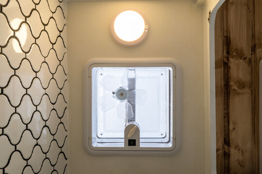 Skylight with fan installed in the bathroom of a camper van