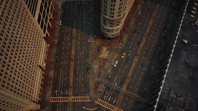 Aerial overhead view of historic city architecture with early morning traffic on multi lane urban streets and intersections.
