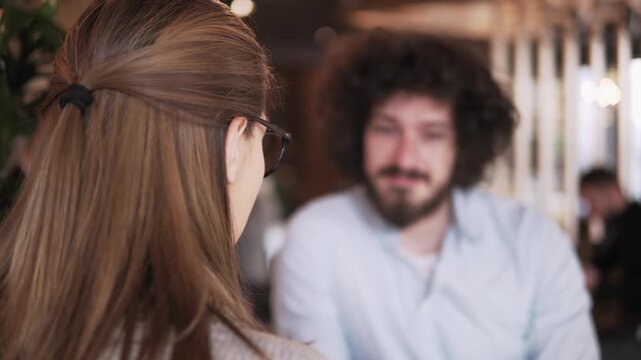 Romantic casual interaction between pair in a cozy coffee shop setting
