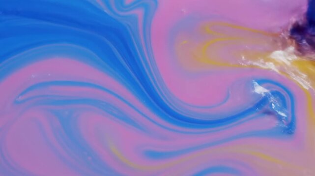 Fluid abstract in vibrant blue, pink, and yellow hues. Swirls and waves define the form