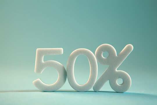 White 50 percent discount on blue background with copy space, business and finance concept