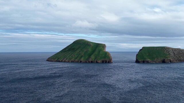 Cinematic drone rotation around Ilheus das Cabras volcanic islets in the Atlantic Ocean near Terceira Island Azores Portugal