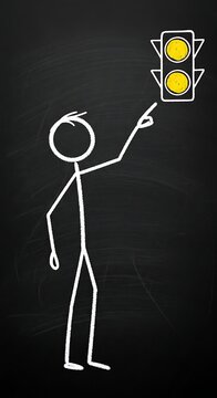 White Chalk Stick Figure Pointing at Yellow Traffic Light on Black Chalkboard