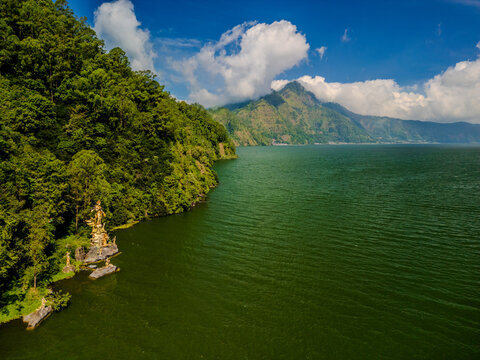 Lake Batur in Kintamani with the golden Dewi Danu statue on the shoreline