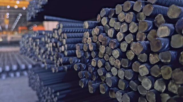 Stacked corrugated steel rebars ready for distribution inside industrial steel mill