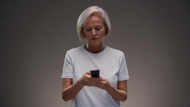 Old woman hand holding tv remote control. Elderly female presses button of device and turns channel, switching surfing. Senior lady with grey hair turn off on television. Recreation and entertainment