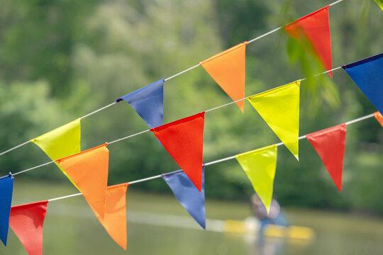 Brightly colored red yellow blue and green bunting flags hanging outdoors
