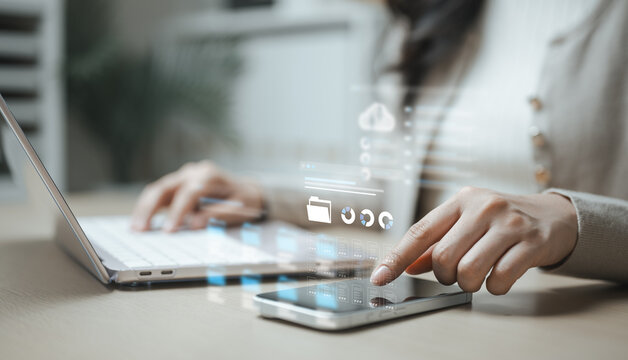 User exporting and downloading personal data archives through a digital account management interface on mobile and laptop devices. Concept of data portability, privacy requests, document storage.