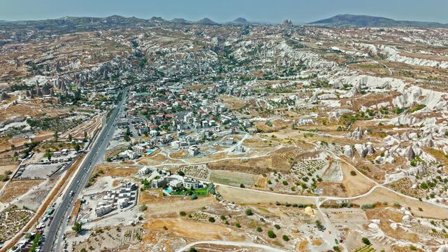 Aerial view of Goreme, Cappadocia, Turkey landscape. Cave houses, dry valleys and fairy chimneys show a unique tourism view.
