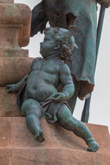 Fototapeta premium On the streets in Spain in public places. Bronze metal sculptures and statues, decoration of urban architecture.