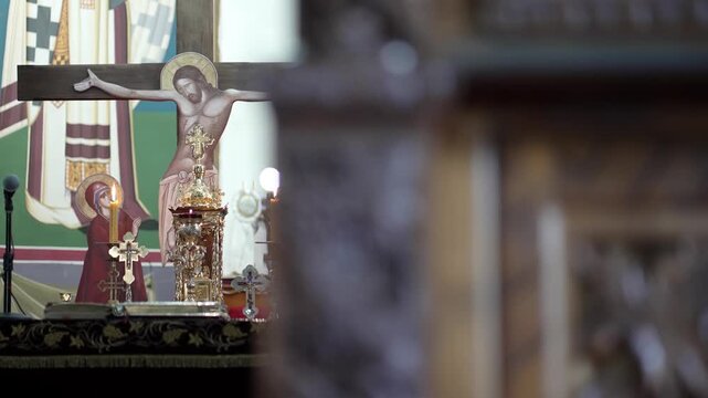 Capture highlights a detailed altar in an Orthodox church, featuring a crucifix and intricate religious artifacts