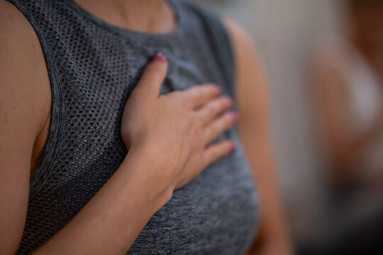 Woman holding hand over chest feeling gratitude