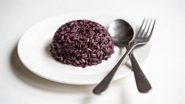 Healthy riceberry rice on white plate, clean white background, top-down view.