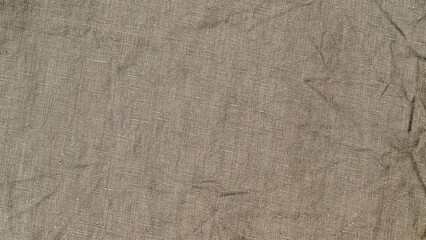 Naklejka premium Simple fabric texture on a table shows threads interwoven in light beige color with soft lines and folds visible