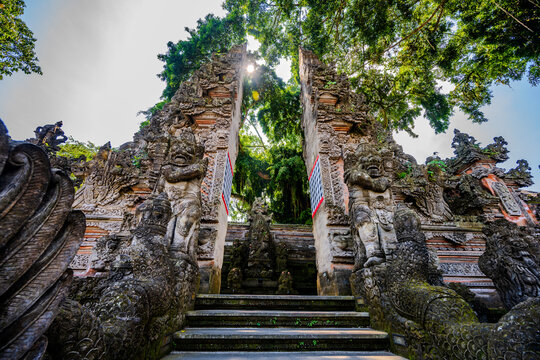 Traditional Balinese split gate with ornate stone carvings in Ubud