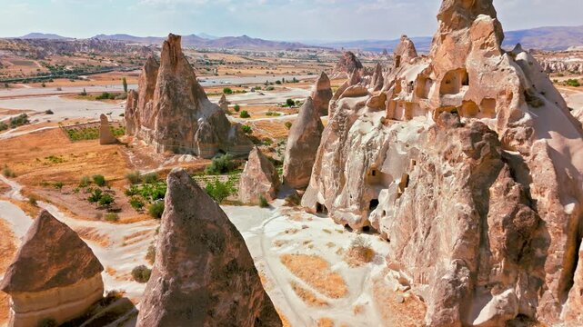 Scenic aerial of Cappadocia, Turkey stone pinnacles. Tall eroded formations and sandy terrain showcase the area&rsquo;s dramatic natural geology.