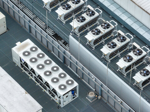 Aerial view of the AI data center cooling units and HVAC systems with multiple fans on a technical rooftop in Warszawa, Wojewodztwo mazowieckie, Poland.