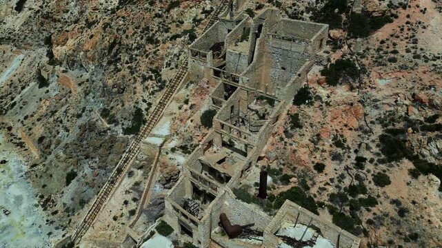 Close to long shot of the Old Slufur Mines Thiorichia, Milos, Greece. Showing the full scale. Shot on a 4k at 60 fps on a DJI Mini 3 Pro in Raw Footage (uncolorgraded), D-Log film