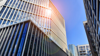 Naklejka premium View of an modern apartment building standing next to a new modern office building with a glass facade.