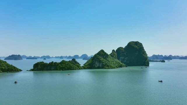 Drone pullback revealing limestone islands across Ha Long Bay Vietnam