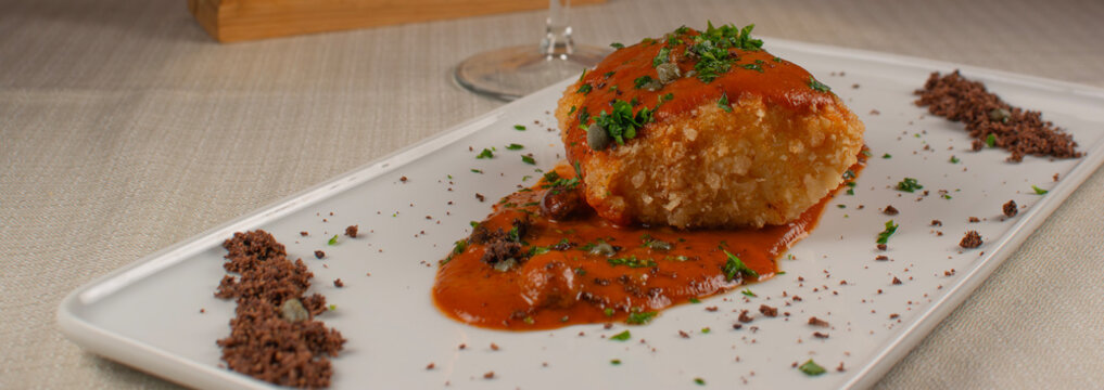 Baccal&agrave; Cod Fish Appetizer with Tomato Sauce on White Plate