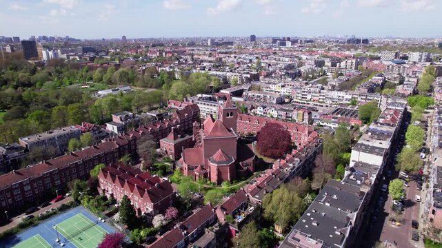 Aerial of residential community neighbourhood Watergraafsmeer in Amsterdam, The Netherlands with city center in the background. Dutch housing market real estate investment